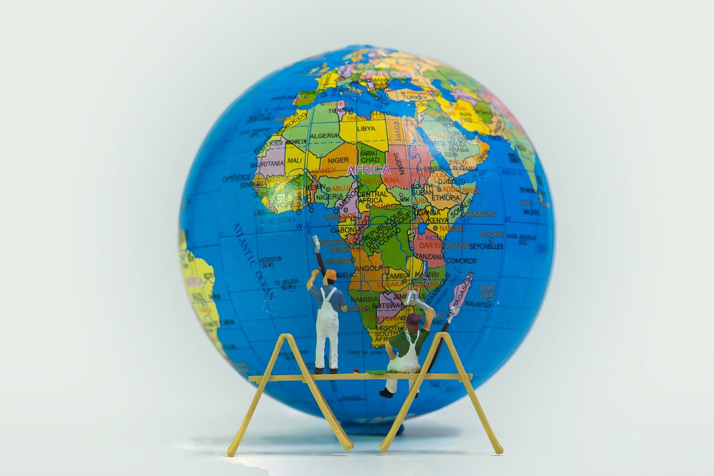 Two,Painters,On,A,Scaffold,Paint,The,Globe,Isolated,On Two,Painters,On,A,Scaffold,Paint,The,Globe,Isolated,On