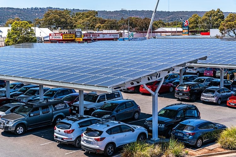 Large car park in Australia with solar structures over the cars, keeping them in shade.