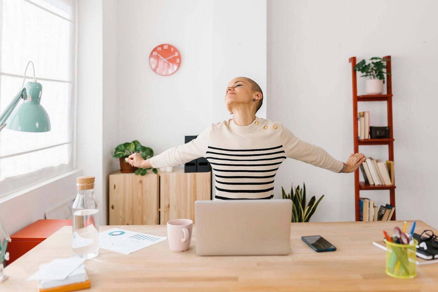 A woman at piece stretching at work, taking a breather