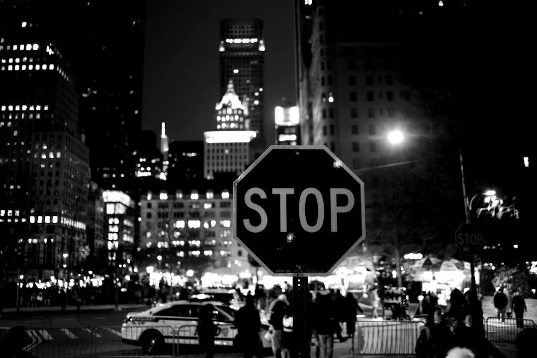 a red stop sign sitting on the side of a road