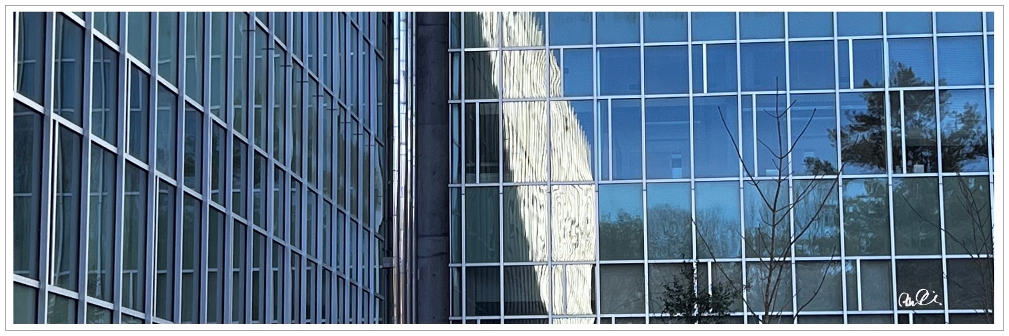 blue glass building, light 'dancing' reflection from metal uprights