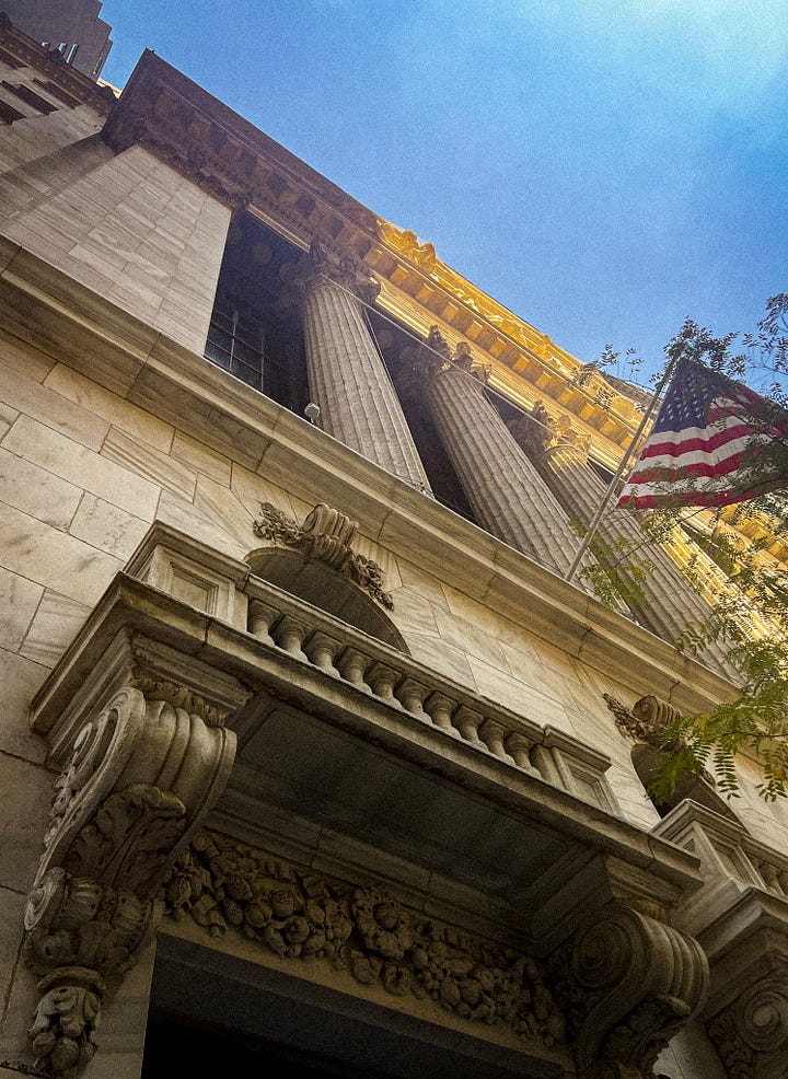 the outside of the NYSE and a photo of me standing in front of the bell