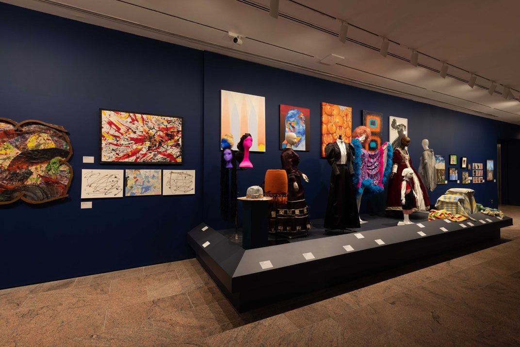Costumes in front of paintings
