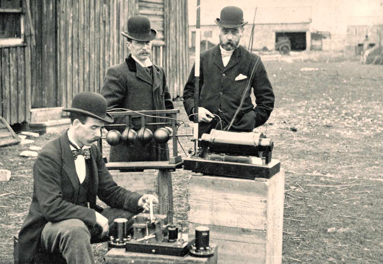 Old photograph of British Post Office engineers inspecting Marconi's radio equipment during a demonstration on Flat Holm Island, May 13, 1897