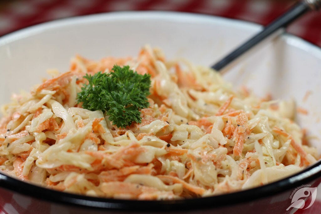 Creamy Coleslaw green cabbage and carrot in serving bowl Creamy Coleslaw green cabbage and carrot in serving bowl
