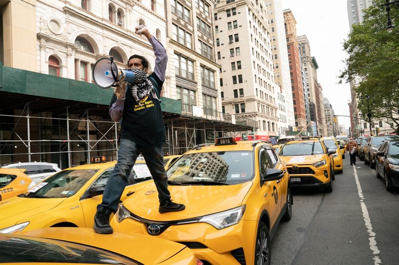 Taxi driver and labor organizer Mohammad Tipu Sultan uses a bullhorn at a cabbie protest outside City Hall on Thursday. Taxi driver and labor organizer Mohammad Tipu Sultan uses a bullhorn at a cabbie protest outside City Hall on Thursday.