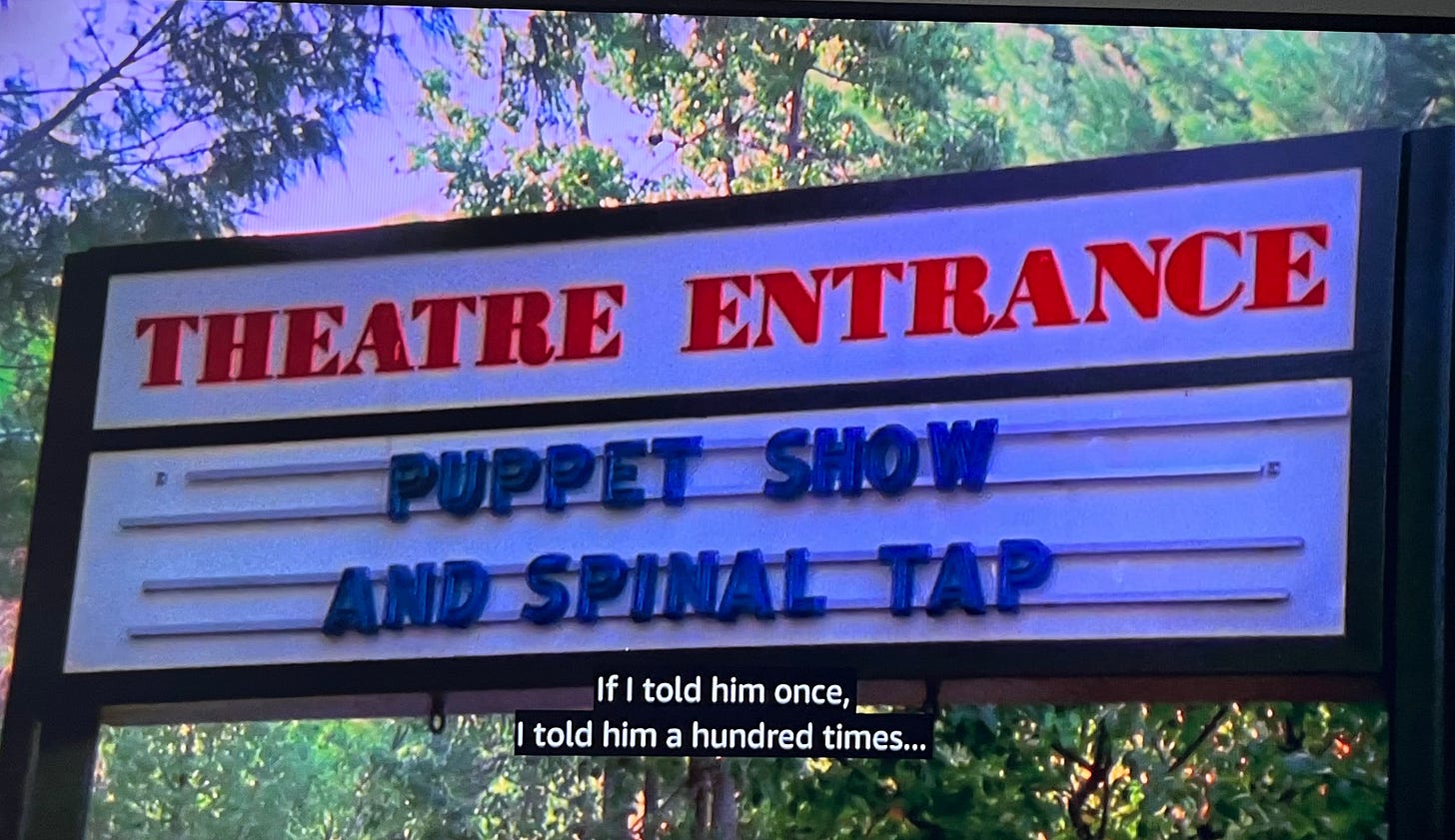 Image from This is Spinal Tap: Theater marquis that says “Puppet Show and Spinal Tap” and Jeanine’s voiceover narration is saying “If I told him once, I told him a hundred times . . .”