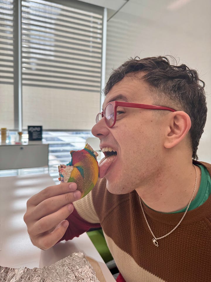 Goran eating the rainbow bagel