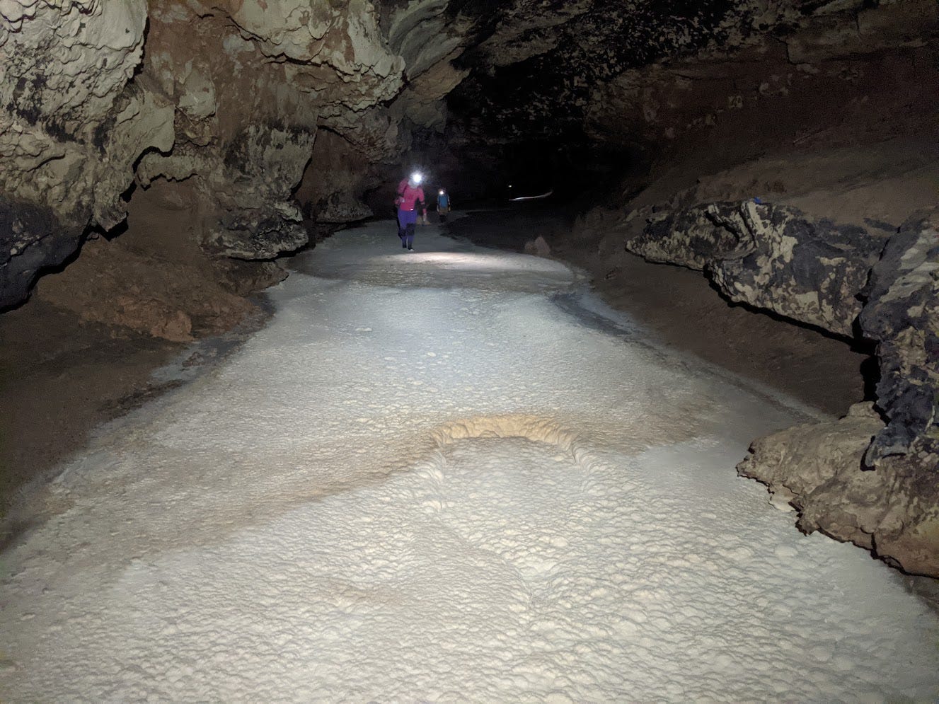 3 cavers walking on large Snowy River passage 3 cavers walking on large Snowy River passage