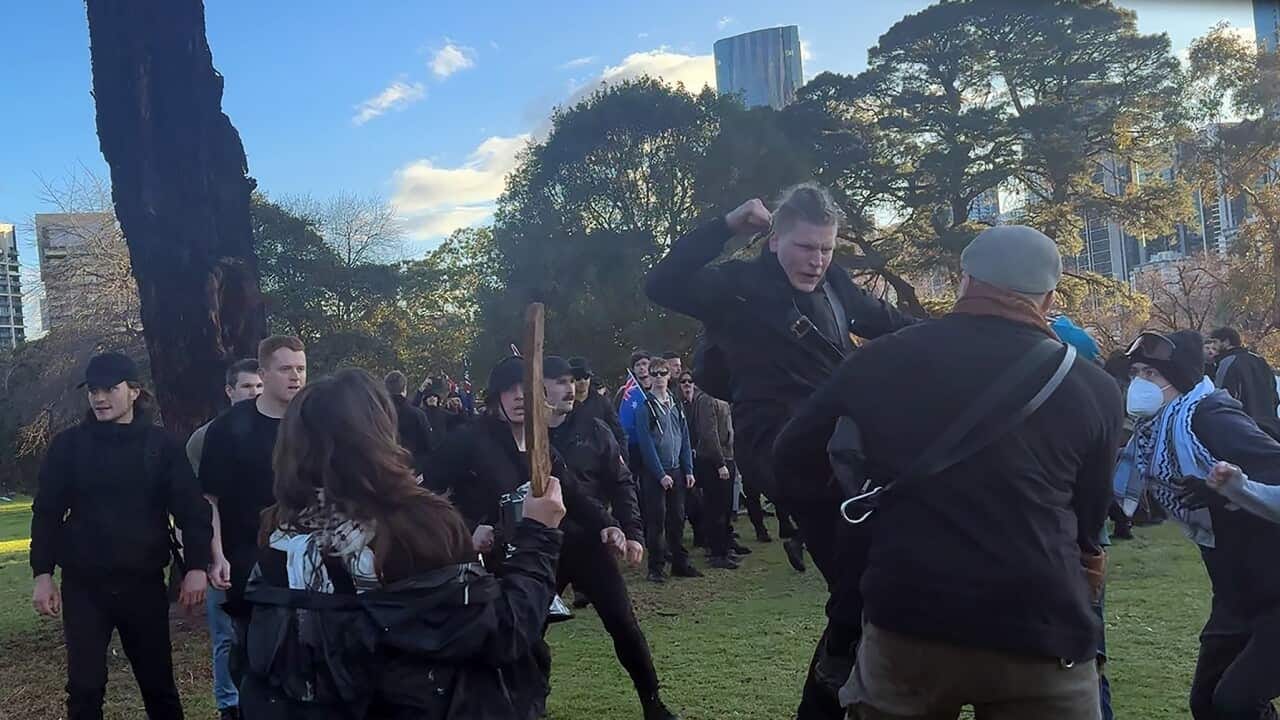 A group of men dressed in black lash out at people at Camp Sovereignty in Melbourne (AAP)