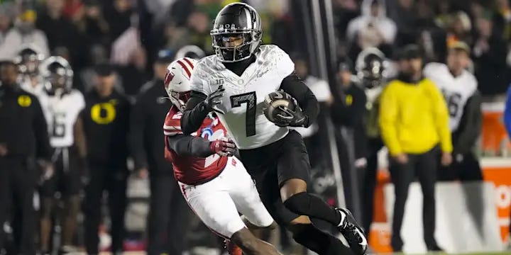 Oregon Ducks wide receiver Evan Stewart (#7) breaks a tackle against Wisconsin during a primetime college football showdown. Exclusive updates, injury news, and insider Oregon football coverage for paid subscribers at Oregon FansEdge