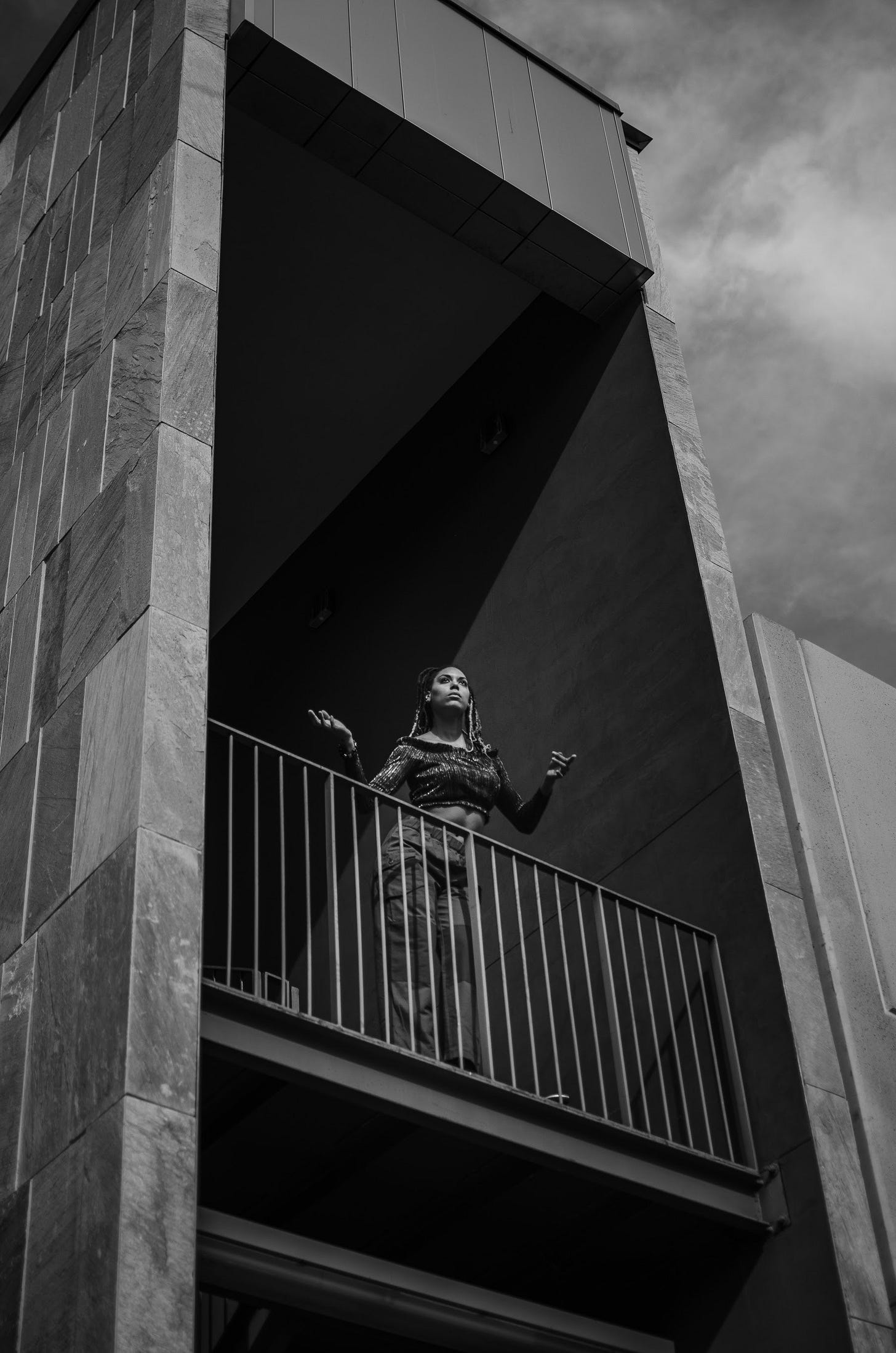 Photo by Jacob M: https://www.pexels.com/photo/unrecognizable-woman-standing-on-balcony-of-building-on-sunny-day-5043054/