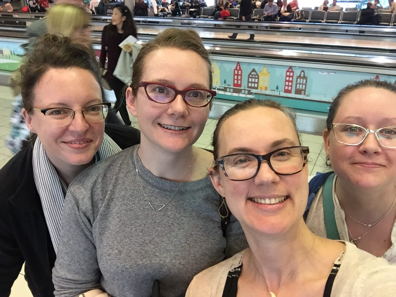 4 women smiling in an airport