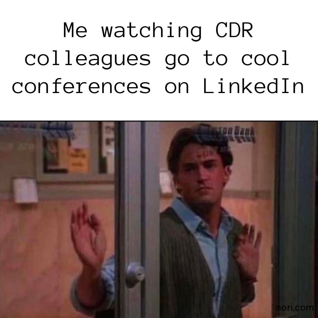 Chandler from Friends with both hands pressed against a glass door, under the text "Me watching CDR colleagues go to cool conferences on LinkedIn".