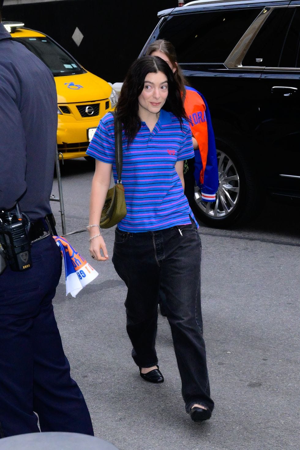 Lorde shows her sporty side in a striped polo at a Knicks game