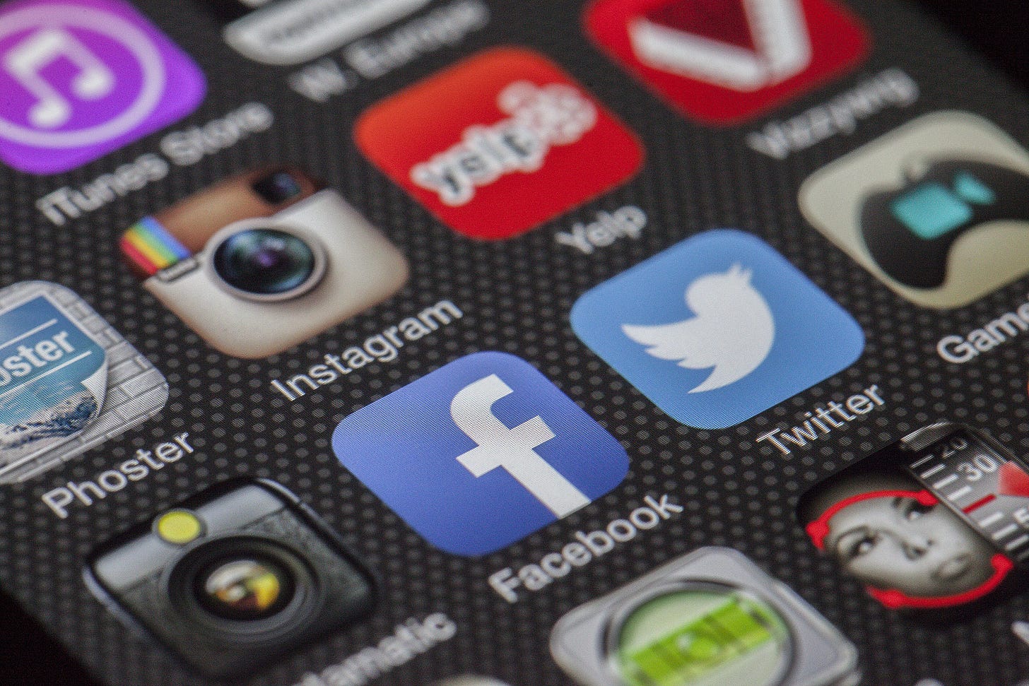 A photo of social media platform icons on a smartphone screen.