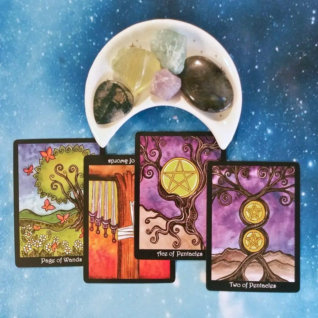 Tree Tarot cards and crystals on a starry blue background Tree Tarot cards and crystals on a starry blue background