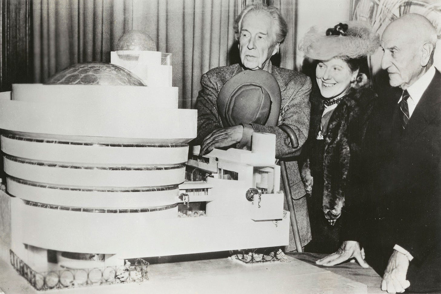 Frank Lloyd Wright, Hilla Rebay, and Solomon R. Guggenheim standing beside the 1945 model of the Guggenheim Museum. © SRGF Archives, New York. Photo: Margaret Carson