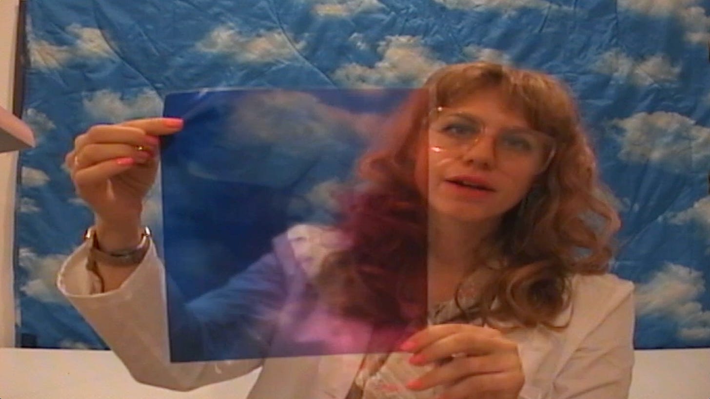 Dr. Fifi Robinson holds up a colorful transparency of an upper cervical spine.