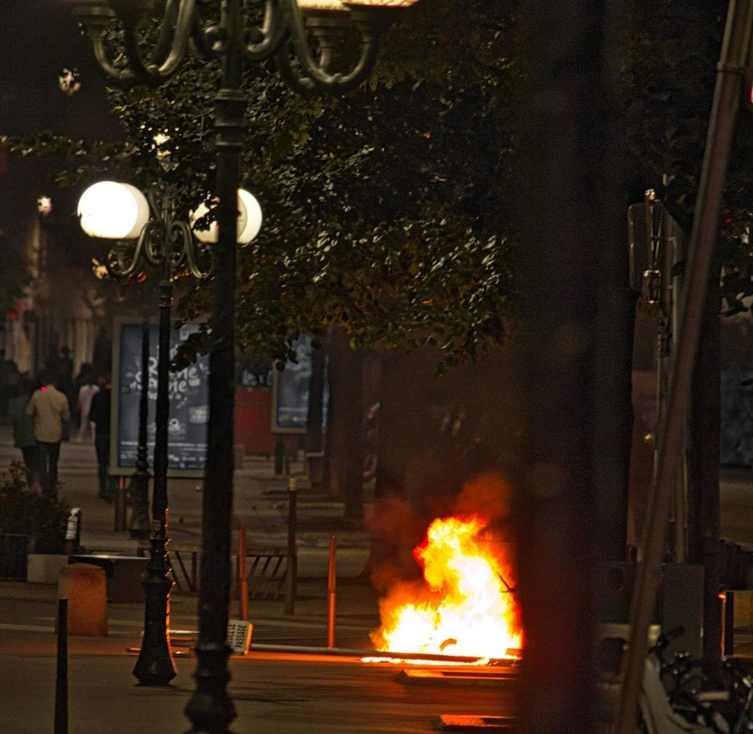 a fire blazing in the middle of a street
