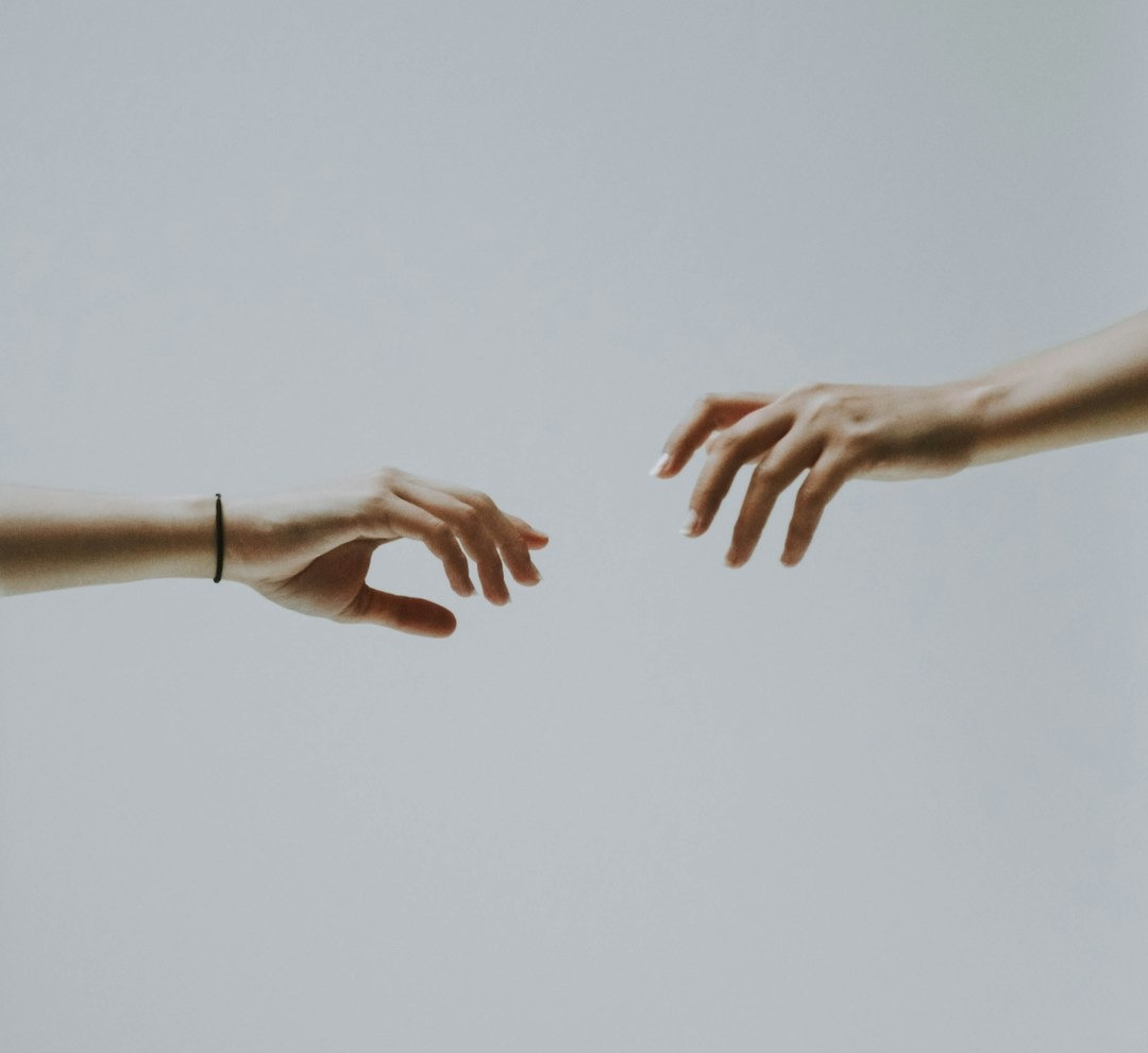 two hands about to hold wallpaper