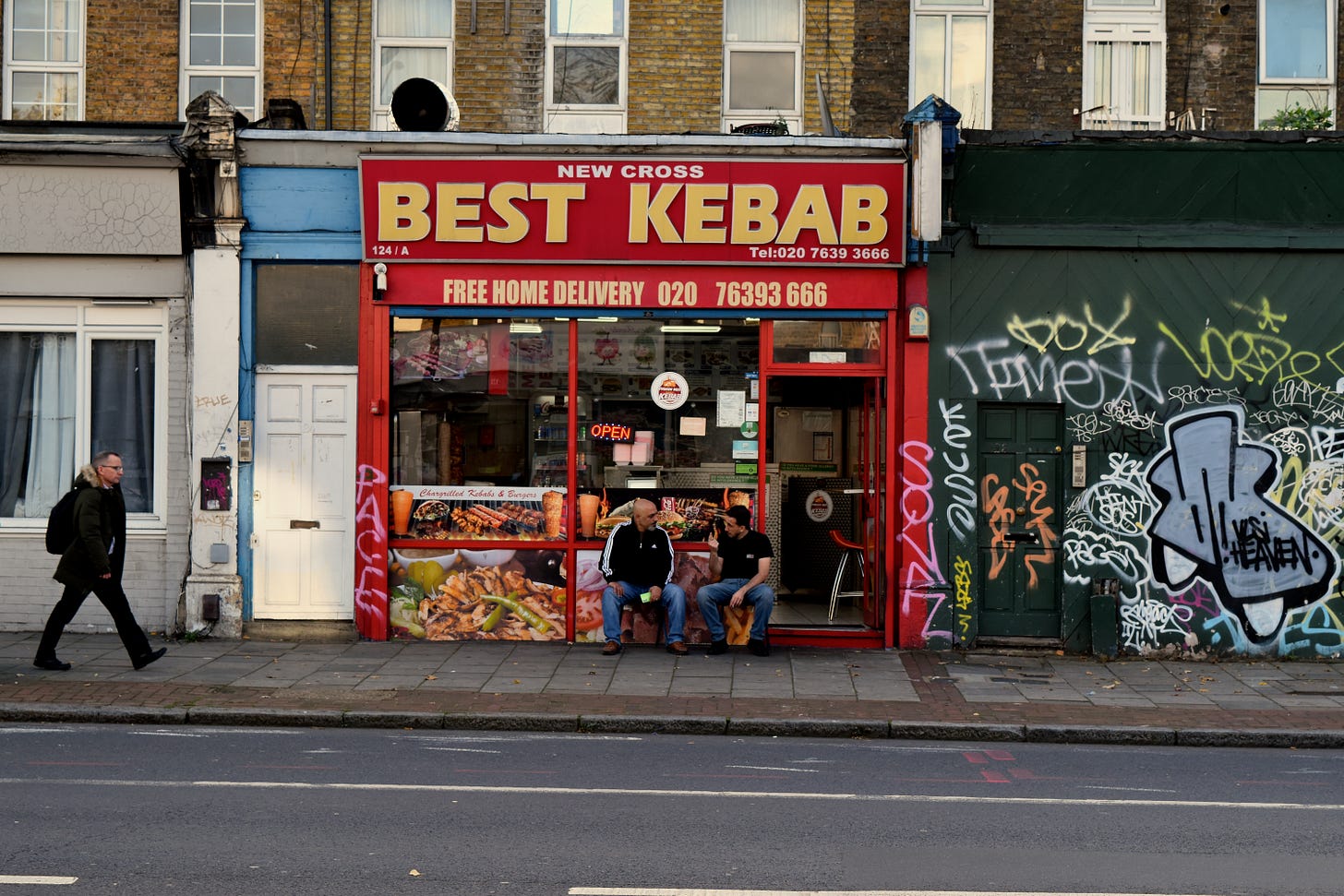 Fellas chatting outside kebab shop 