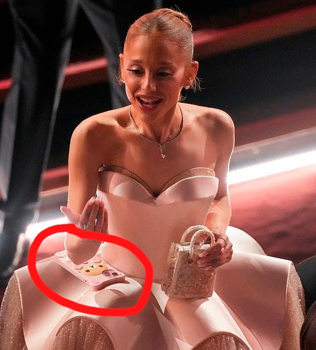 One of the funniest behind-the-scenes visuals occurred when Ariana Grande repurposed her dress' rigid skirt as a phone holder