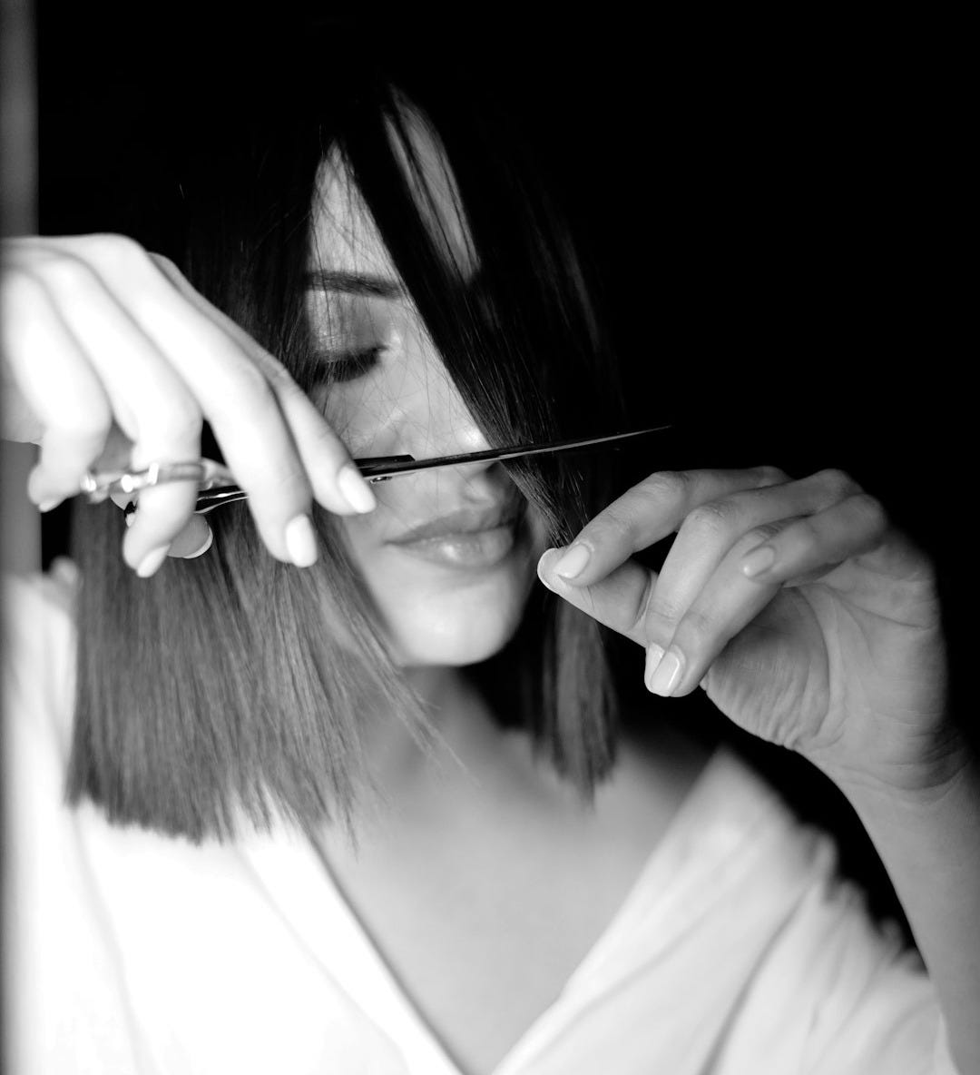 woman in v neck shirt holding her hair