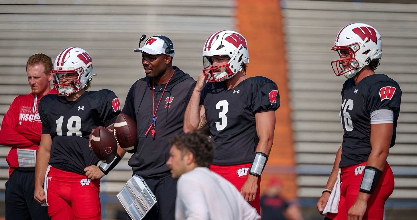 Wisconsin quarterbacks coach Kenny Guiton stands with Carter Smith and Danny O’Neil during fall camp.