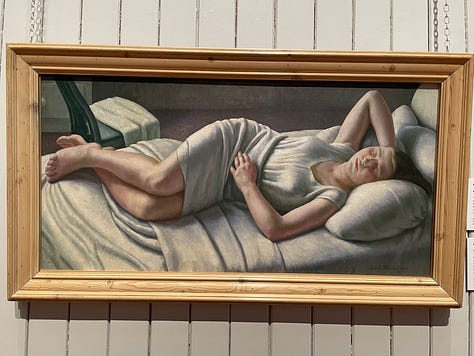 Portrait of a dog's head; 50s style poster of three women playing in the sea; reclining woman in bed