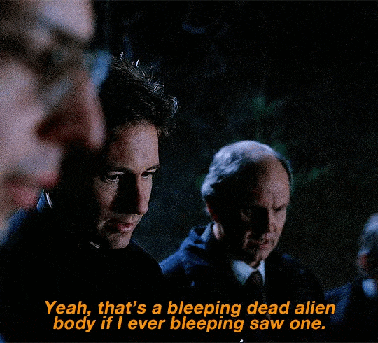 Image first of a dead "alien" body. The detective on the far right says "Yeah, that's a bleeping dead alien body if I ever bleeping saw one." Image first of a dead "alien" body. The detective on the far right says "Yeah, that's a bleeping dead alien body if I ever bleeping saw one."