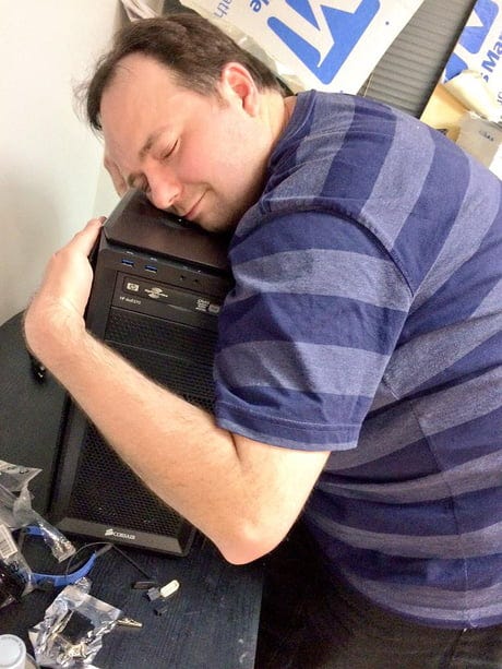 Founder hugging desktop computer after successful AI-generated deployment
