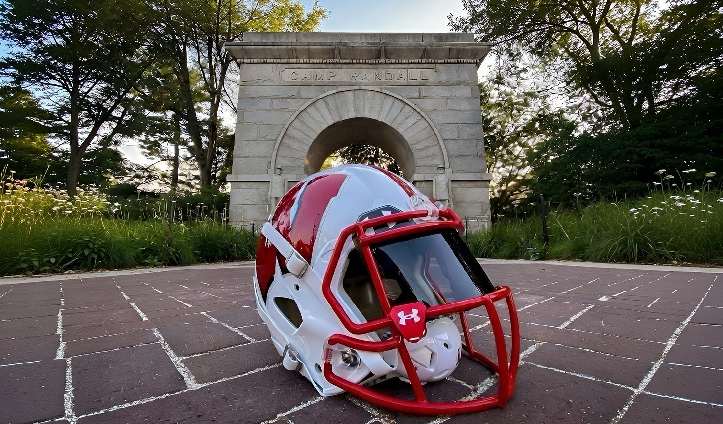 Wisconsin Badgers football helmet lying on the bricks in front of the Camp Randall Arch. Photo credit: Aaron Frey.