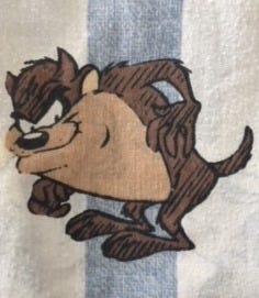 Image of Tasmanian Devil from Bugs Bunny, smirking, on white sheet with light blue stripe running behind him.