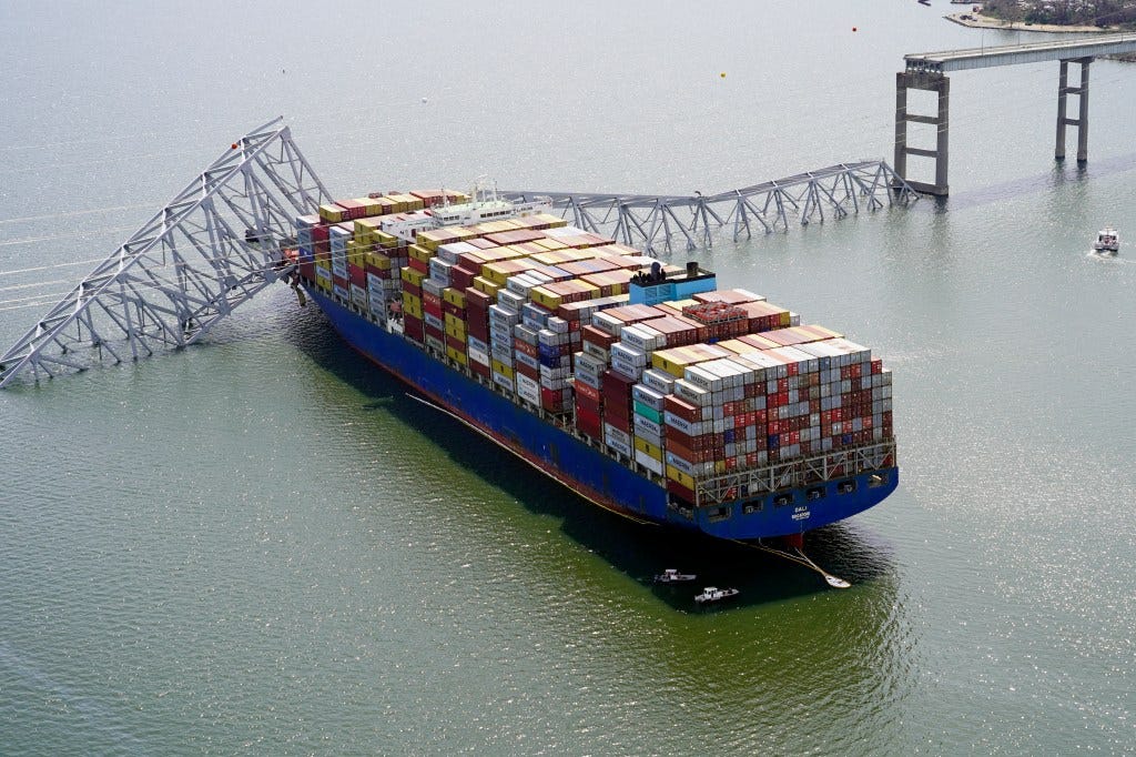 In this photo provided by the Maryland National Guard, the cargo ship Dali is stuck under part of the structure of the Francis Scott Key Bridge after the ship hit the bridge on March 26. In this photo provided by the Maryland National Guard, the cargo ship Dali is stuck under part of the structure of the Francis Scott Key Bridge after the ship hit the bridge on March 26.