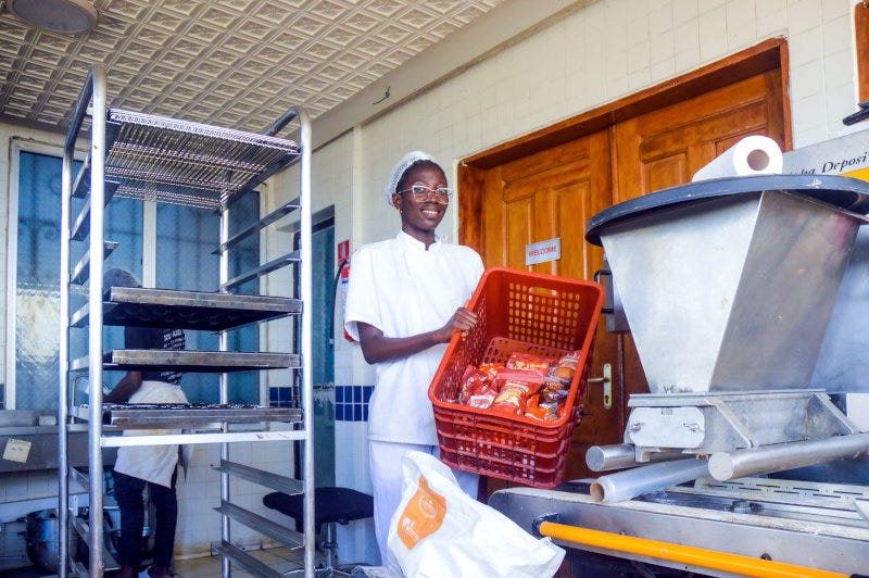Adeline Pelage holding a crate of biscuits in the Biscuiterie Bobo factory in Douala, Cameroon. Adeline Pelage holding a crate of biscuits in the Biscuiterie Bobo factory in Douala, Cameroon.