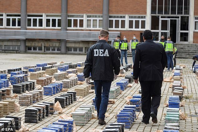 A US Drug Enforcement Administration (DEA) officer walks among bundles of cocaine seized during a press conference held by Spanish National Police in Madrid, Spain A US Drug Enforcement Administration (DEA) officer walks among bundles of cocaine seized during a press conference held by Spanish National Police in Madrid, Spain