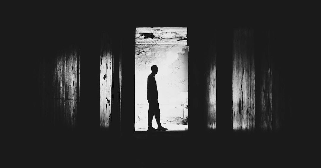silhouette of man in dark room