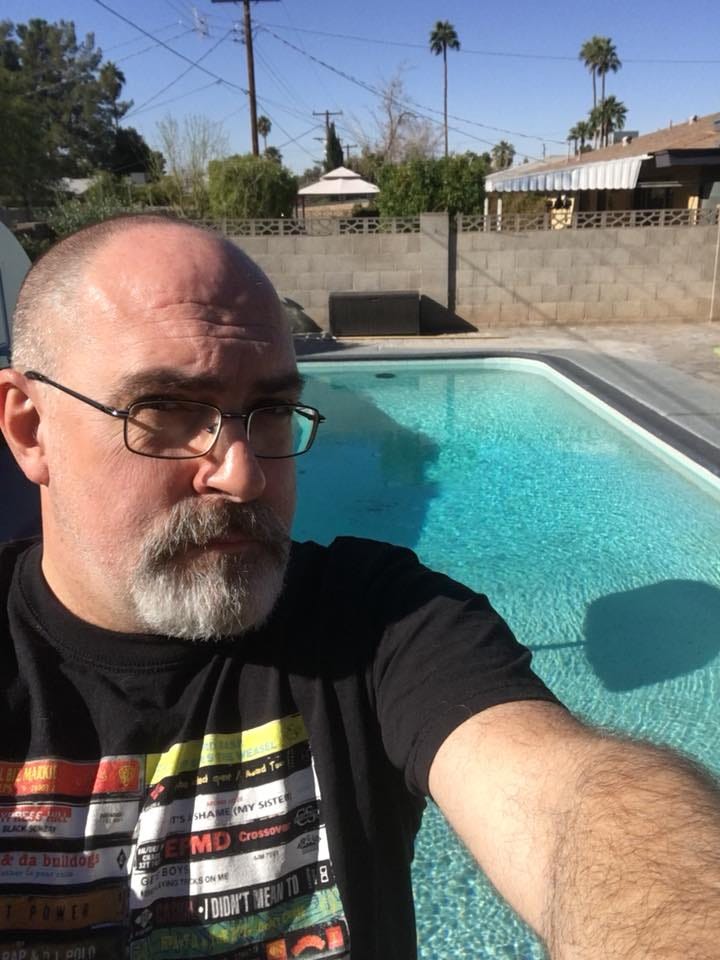 Brian Keene standing in front of a swimming pool in Arizona