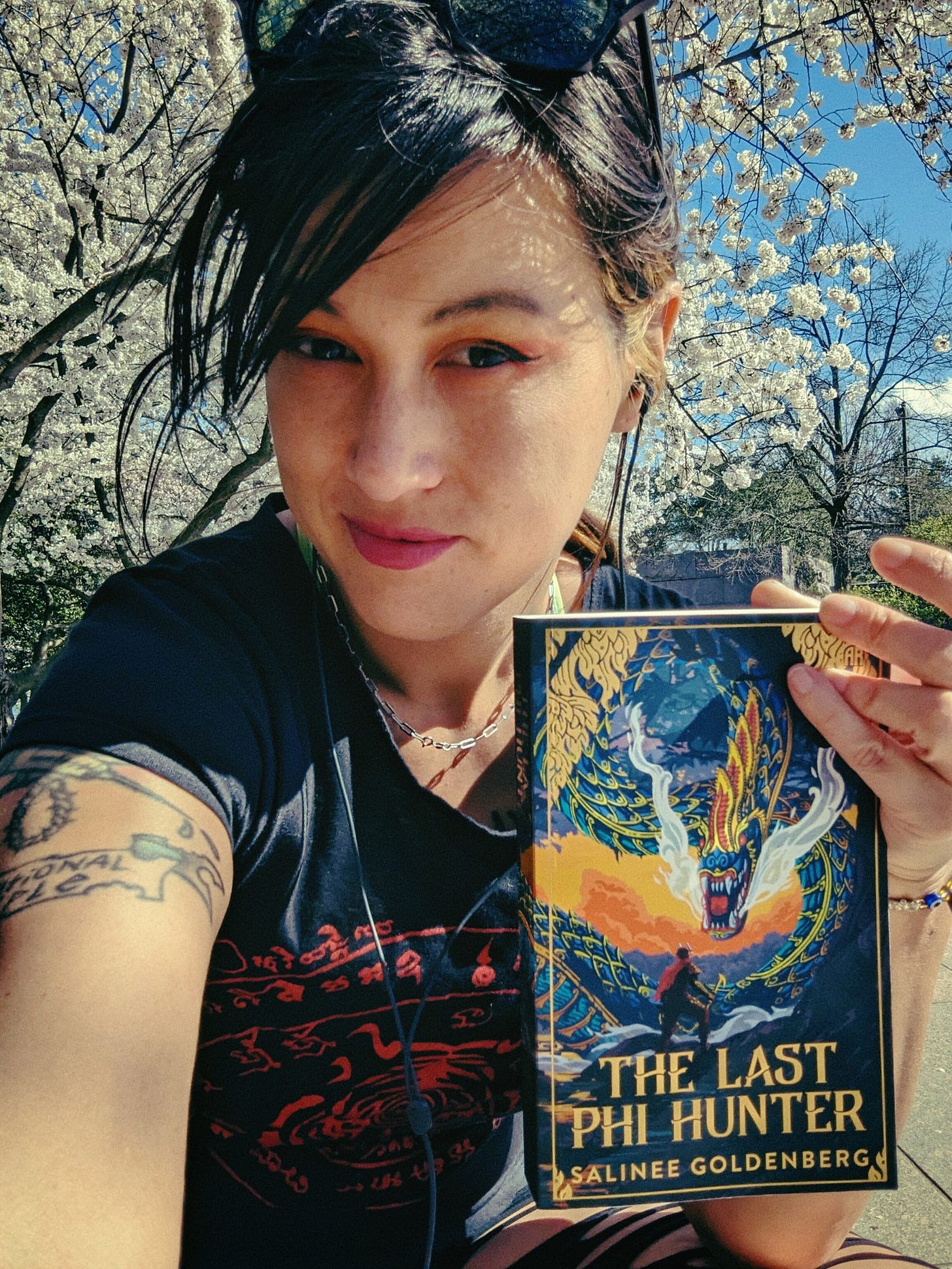 Author Salinee Goldenberg holding her book The Last Phi Hunter