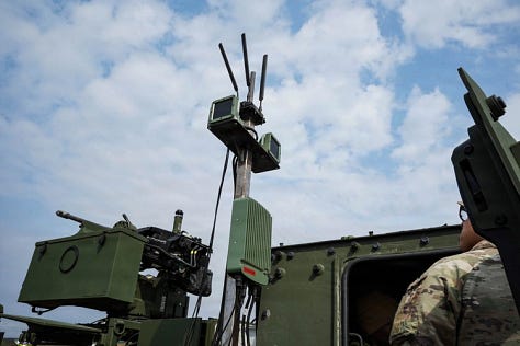 U.S. Army soldiers training with Titan V3 counter-unmanned aerial system technology in a wooded Latvian environment during the multinational Saber Strike 26 exercise.