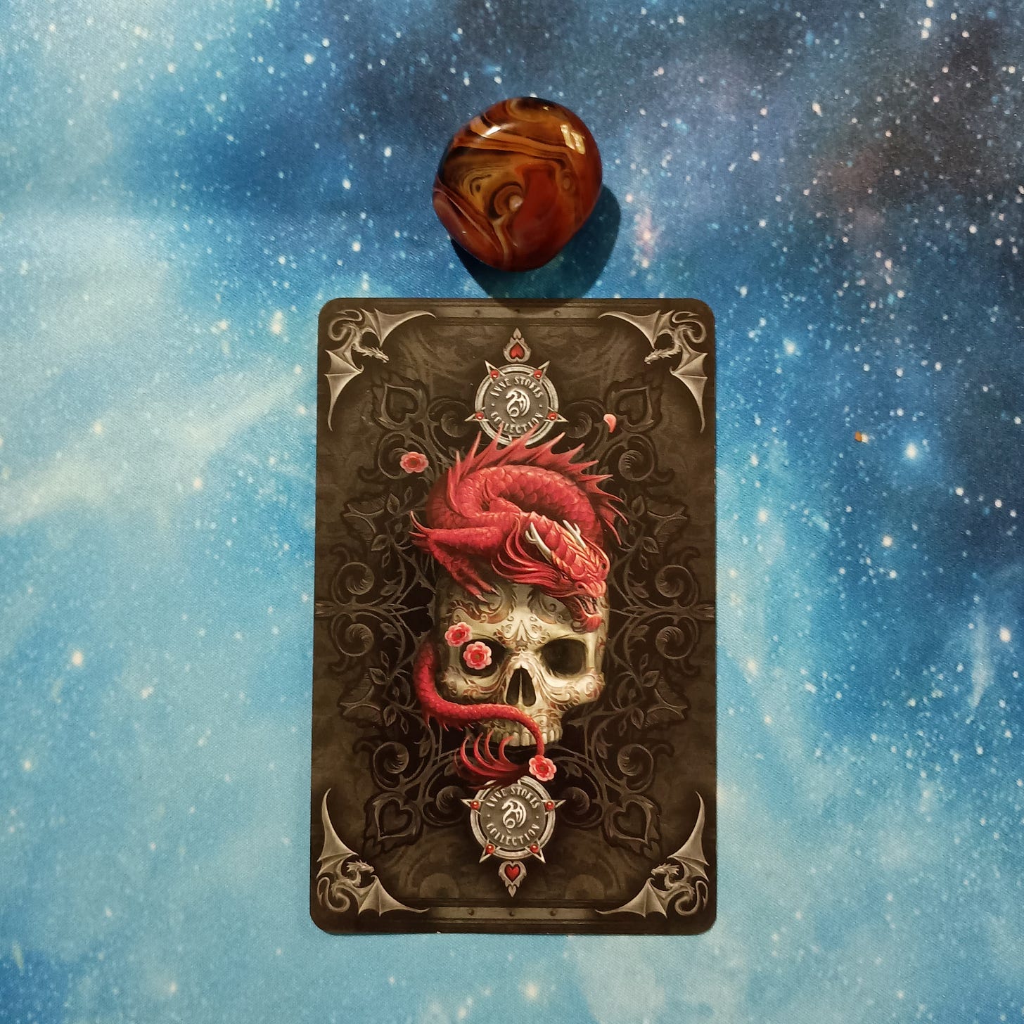 Full Moon Magic: Your August 2025 Pick-a-Card Tarot Reading, Pile 2, Silk Agate crystal on a starry blue background, and 1 oracle card, face down Full Moon Magic: Your August 2025 Pick-a-Card Tarot Reading, Pile 2, Silk Agate crystal on a starry blue background, and 1 oracle card, face down