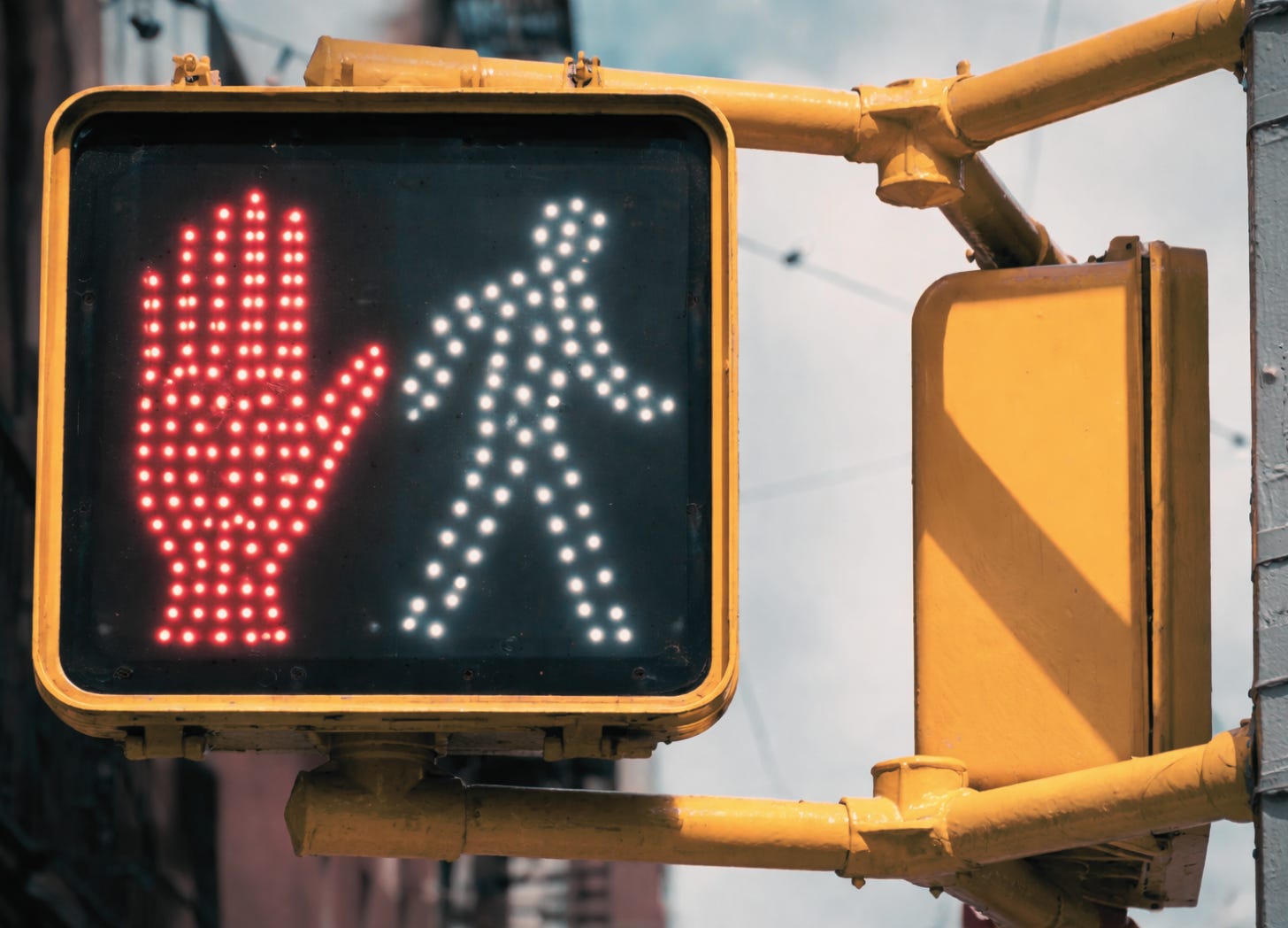Pedestrian crosswalk signal showing both “Walk” and “Don’t Walk” symbols illuminated at the same time. Pedestrian crosswalk signal showing both “Walk” and “Don’t Walk” symbols illuminated at the same time.
