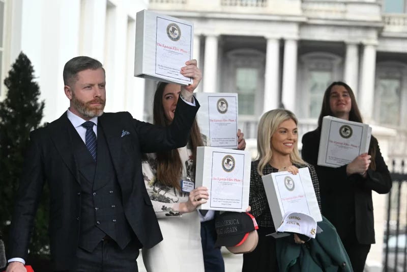 Five people in suits hold up binders that sayEpstein Files, part 1 Five people in suits hold up binders that sayEpstein Files, part 1