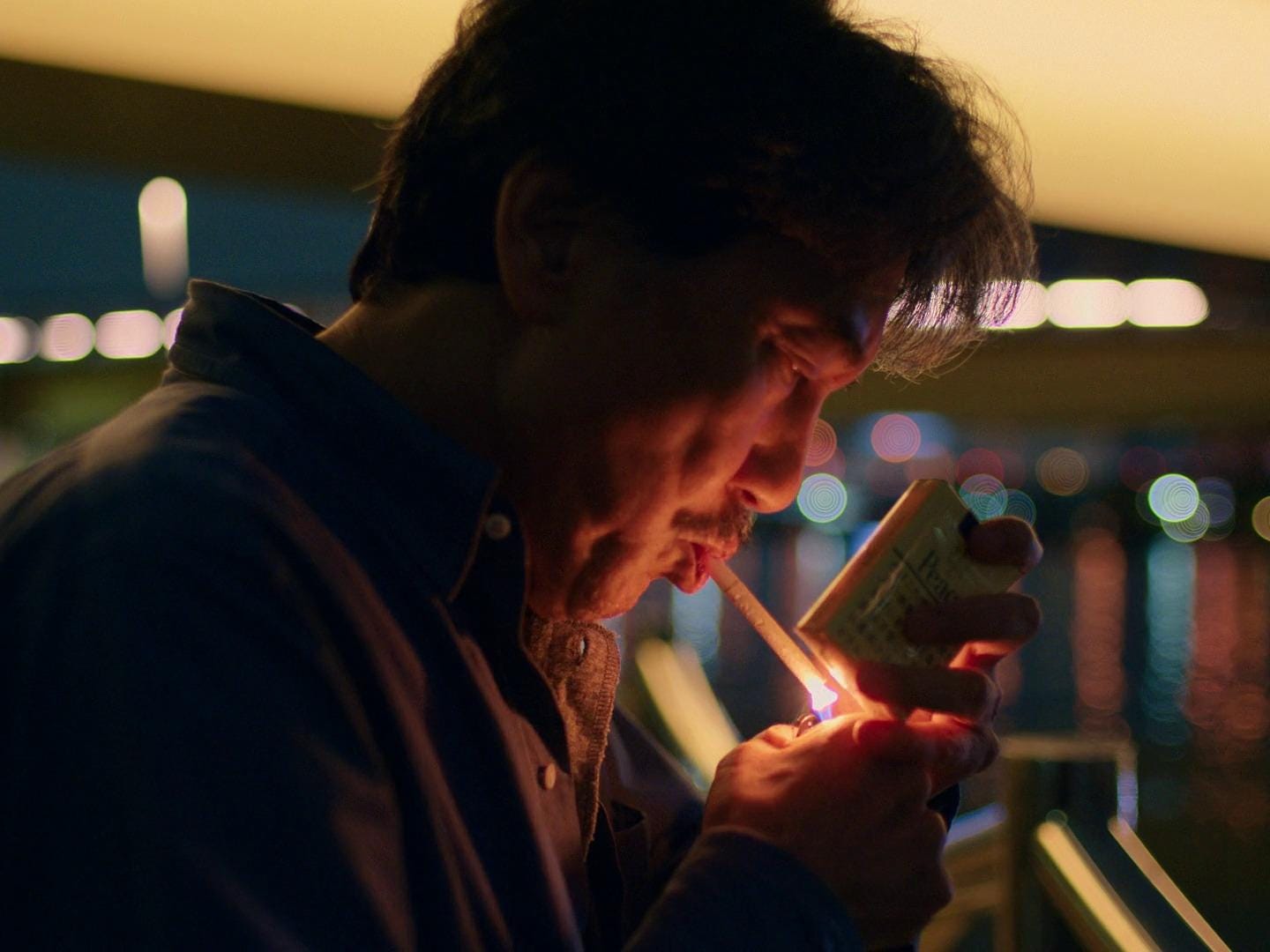 guy watching movie with cigarette Cigars in Cinema: Iconic Scenes a Smoky Twist  Route 30 Cigars Man Lighting Up A Cigarette