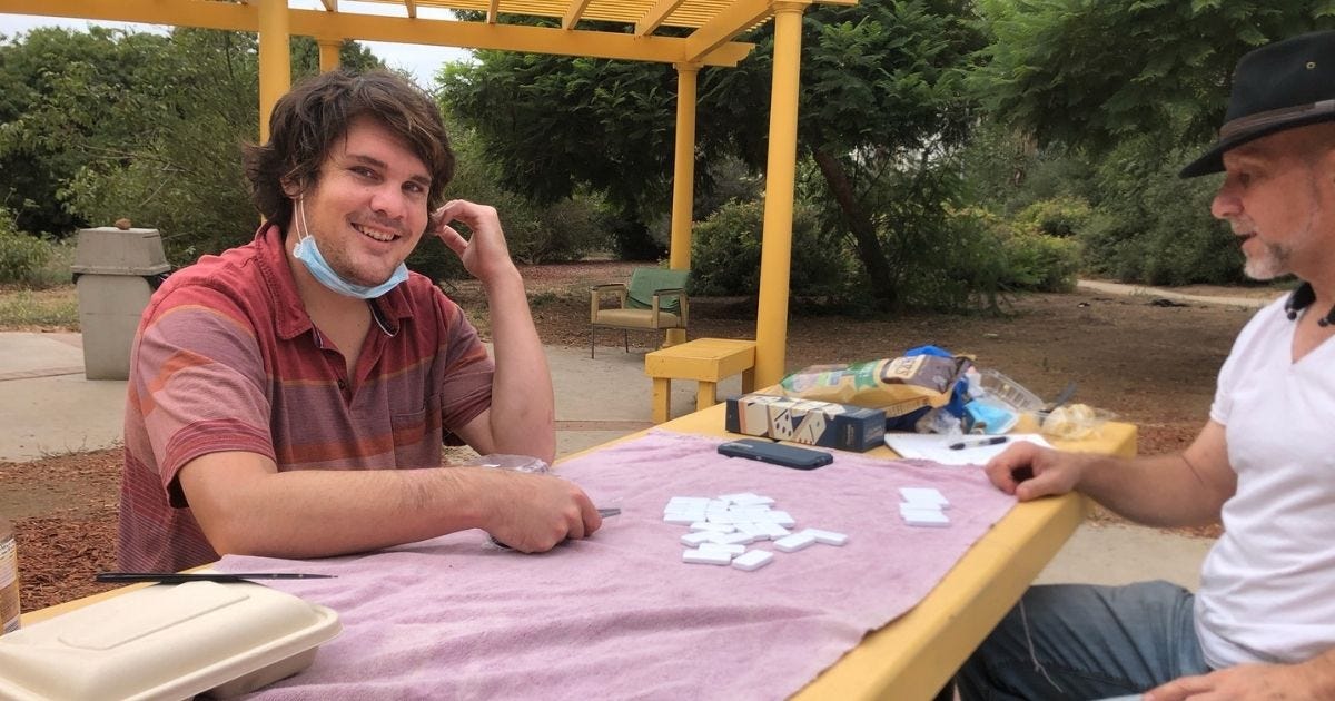 Image of Christopher and I playing dominoes when he was in rehab a couple years ago