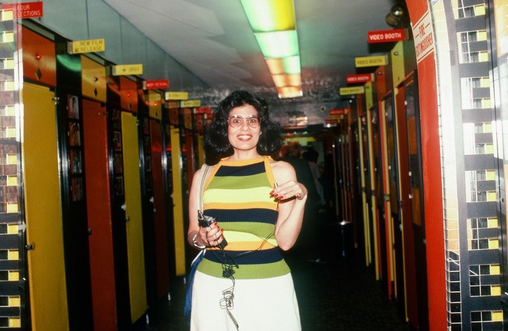 My sweater matches the video booths decor. Viewers pumped in tokens to get to the sex scenes. (photo: A. Sprinkle)