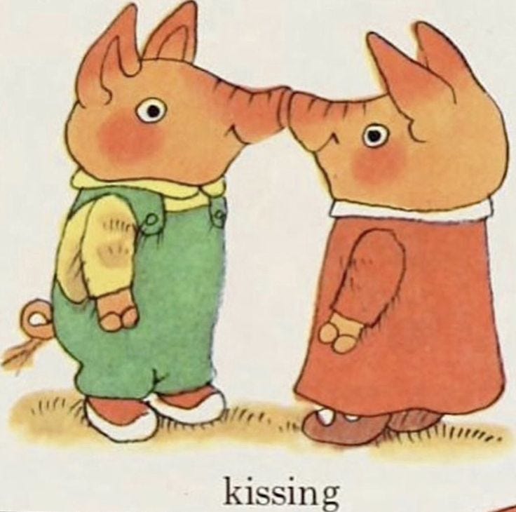 This may contain: two little pigs kissing each other in front of the caption that reads, kissing