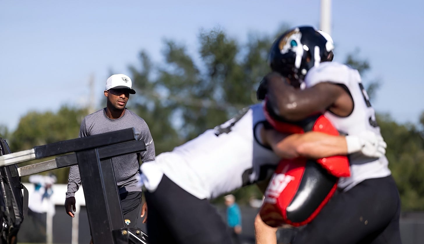 Jacksonville Jaguars assistant coach Ari Confessor instructs players during a team practice session. Jacksonville Jaguars assistant coach Ari Confessor instructs players during a team practice session.