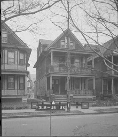 A house with a tree in front of it

Description automatically generated